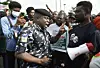 A police officer talks to a protester during a demonstration in Lagos, against bad governance, insecurity, and the ban of social media platform X (then known as Twitter) by the Nigerian presidency, on June 12, 2021.