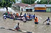People affected by floods are escorted through flood water on a military boat in Maiduguri on September 12, 2024. Severe flooding in the northeastern Nigerian city of Maiduguri has claimed at least 30 lives and forced 400,000 people from their homes, officials said on September 11, 2024.
