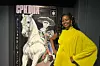 Nyasha Kadandara stands smiling in front of a CPH:DOX festival poster, wearing a bright yellow dress at the 2025 documentary film festival in Copenhagen