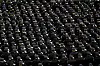 Hundreds of police stand in formation wearing ceremonial uniforms.