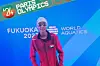 Rana Saadeldin standing in front of the blue World Aquatics Championships banner, wearing goggles.