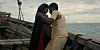 A still from the film of a man and woman holding each other on a boat