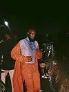 man in orange suit partying in Lagos, Nigeria.