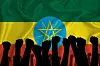 A silhouette of raised arms and clenched fists on the background of the flag of Ethiopia.