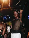 man holding plastic cup during party.