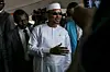 A photo of Mahamat Idriss Deby Itno (C) wearing an all white outfit.