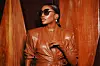 An image of Chioma Ikokwu in a brown leather outfit with her head turned to the side, wearing sunglasses.