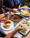 A table of food, including Kiano Moju\u2019s Berbere Braised Pork Tacos