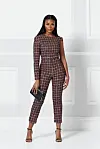 An image of a model standing in a houndstooth Rebecca Tembo jumpsuit