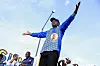 Brice Oligui Nguema on stage with outstretched hands during his last electoral campaign.