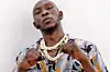 Seun Kuti poses in a boxing stance in a promotional press image.