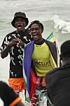 Paul Sampson celebrating in the water, wearing ascsurf gear and wrapped in a South African flag.