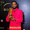 A photo of Chimezie Imo holding his Trailblazer Award plaque at the 2024 Africa Magic Viewers' Choice Awards (AMVCA).