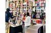 The interior of Soma Nami Books showing book displays and people browsing and chatting.