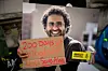 A man holds signs and placards with a photo of imprisoned author Alaa Abd el-Fattah during a protest calling for his release at the Foreign & Commonwealth Office on October 18, 2022 in London, England.