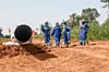 Workers from Niger and China are seen on the construction site of an oil pipeline in the region of Gaya, Niger, on October 10, 2022.