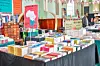A table stacked with books and a red sign that reads \u201cSouthern Africa\u201d at The African Book Fair.