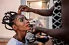 A model gets her make-up done ahead of the first Central African Fashion Week in a makeshift dressing room at the Ledger Hotel in Bangui, December 17, 2022.