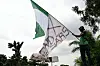 'Flag Boi' Akinwunmi Ibrahim Adebanjo waves the Nigerian flag together with a white flag with the inscription “EndSARS” as youth prepare to commemorate the first anniversary of the protest movement in Lagos, October 11, 2021.