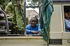 A man sits in a Tanzanian police vehicle after being arrested ahead of a demonstration over the alleged kidnapping and killing of opposition members in Dar es Salaam on September 23, 2024.