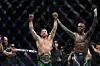 Dricus Du Plessis of South Africa has his arm raised by Israel Adesanya of Nigeria after winning the Middleweight championship fight by submission during UFC 305 at RAC Arena on August 18, 2024 in Perth, Australia.
