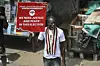 A man holds a sign reading 'we need justice and peace in this election.'