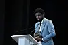 A photo of Joel Kachi Benson holding the Best VR Story Award he received for \u201cDaughters of Chibok\u201d at the 76th Venice Film Festival in 2019.