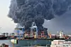 Smoke rises after explosions at South Port of the city of Port Sudan, Sudan