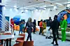 Big Brother Nigeria contestants, men and women, in a room with a table and chairs, and couches