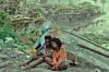 Two young Black characters sit on the ground amid debris in a scene from Memory of Princess Mumbi.