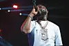 Davido live on stage wearing a white t-shirt, and a chunky silver chain