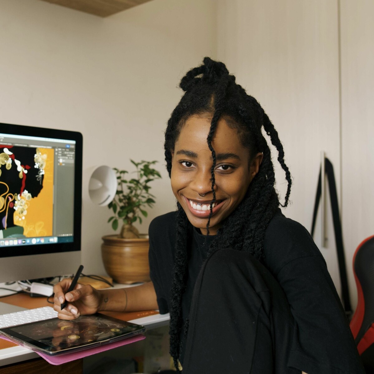 South African digital artist Naledi Modupi working on a graphics tablet in her studio